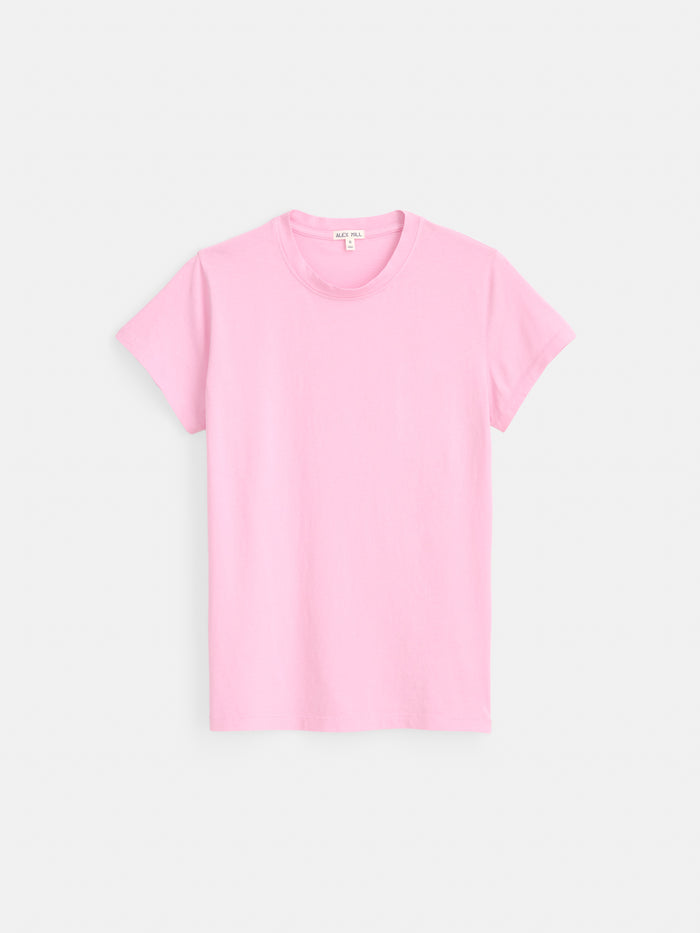 The Prospect Tee In Cotton Jersey, a garment-dyed, short-sleeve t-shirt in light pink and made from 100% cotton, is displayed against a white background.