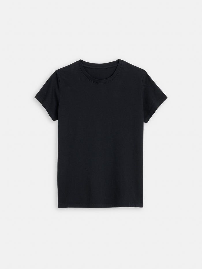 The Prospect Tee In Cotton Jersey, a plain black short-sleeve t-shirt made in Peru from 100% cotton, is laid flat on a white background, showing the front with a round neckline and no visible logos or patterns.