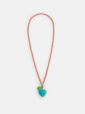 The Roxanne Assoulin Long Happy Cord Charm Necklace features a playful design with orange and white cording, a blue heart-shaped pendant, and a small green charm—both showcased against a white background. This cheerful accessory also comes with detachable charms for added versatility.