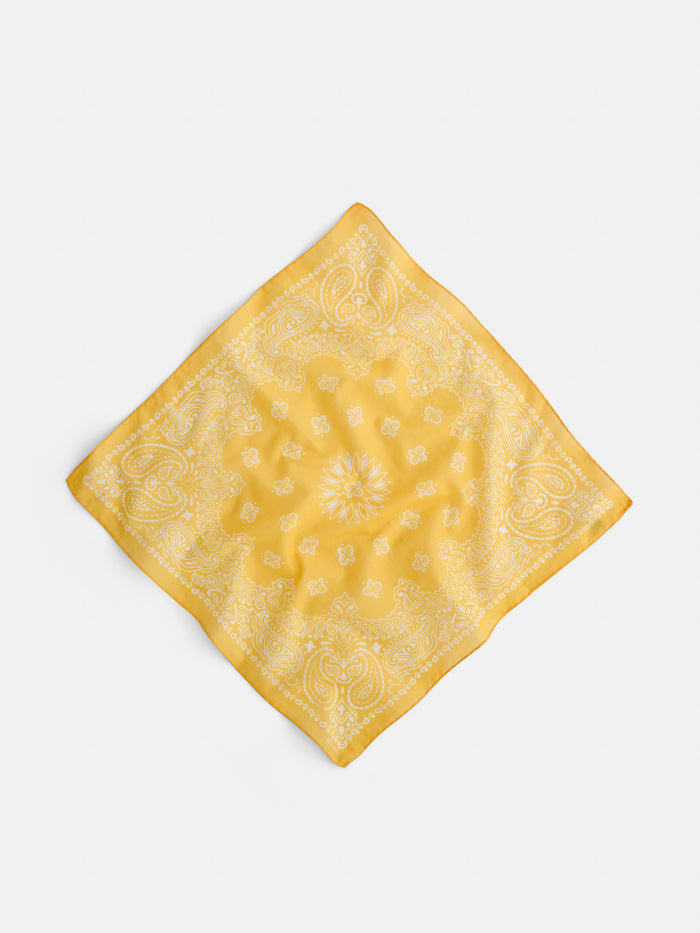 The Two Tone Bandana in Cotton is a vintage Italian bandana, crafted from yellow cotton voile with white paisley and floral patterns, displayed diagonally on a plain white background.