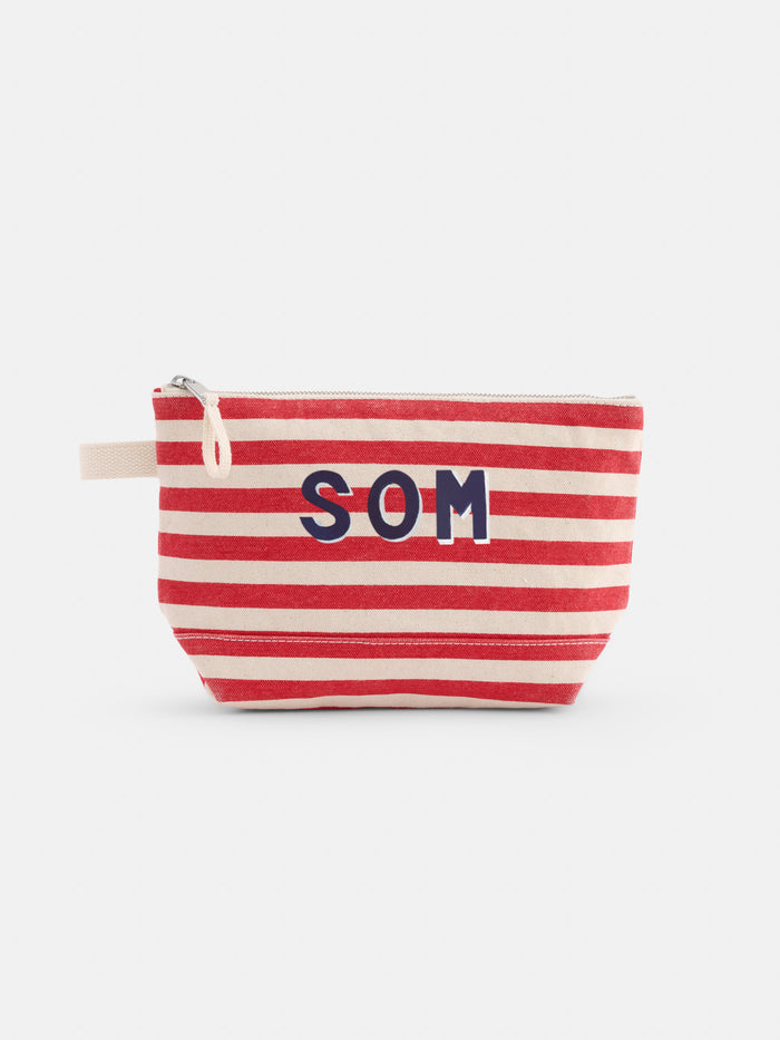 The Perfect Canvas Pouch in Stripe is a small pouch with red and white horizontal stripes, bold SOM letters on the front, and a beige fabric loop on the left side.