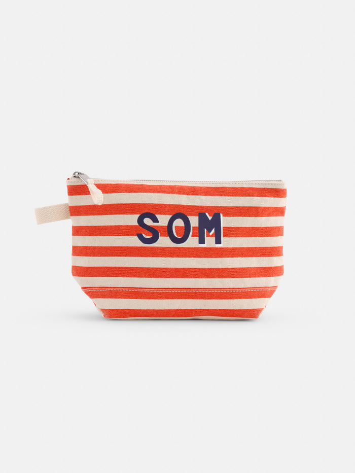 The Perfect Canvas Pouch in Stripe features bold navy "SOM" letters, horizontal red and beige stripes, and a beige zipper—ideal as a stylish makeup bag or personalized pouch.