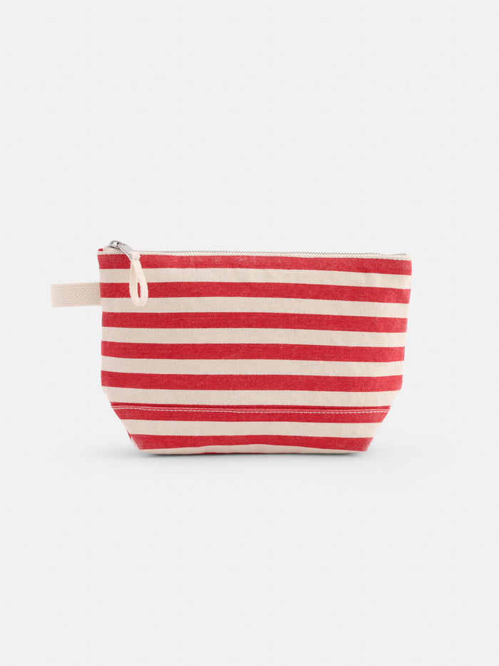 The Perfect Canvas Pouch in Stripe is a small bag with horizontal red and cream stripes and a fabric loop on one side, shown against a plain white background.