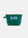 The Perfect Canvas Pouch is a durable makeup bag with a zipper and side strap, personalized with the letters BJW in white and blue on the front.