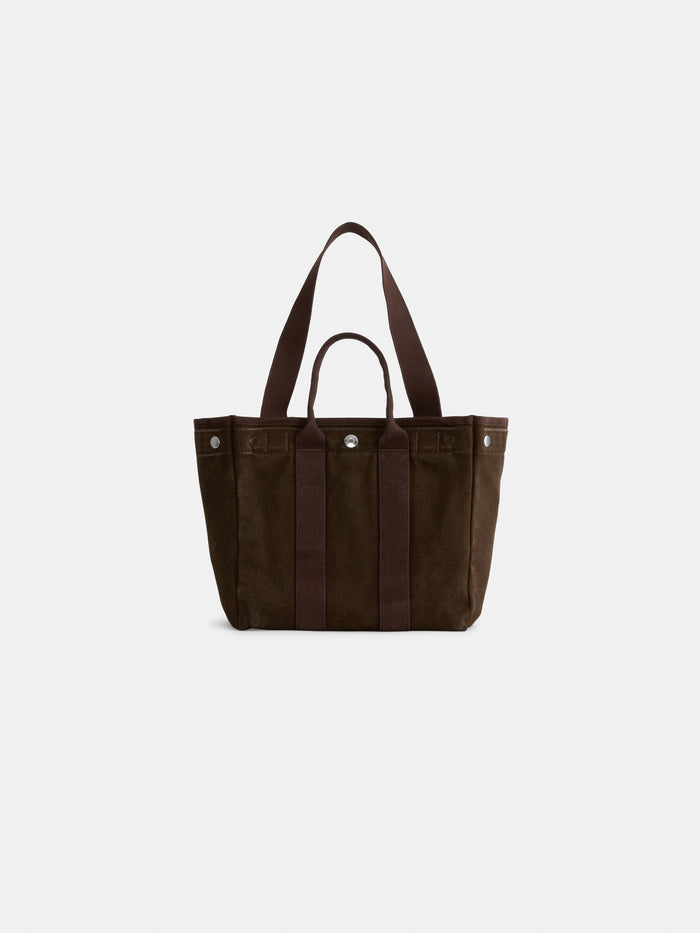 Introducing The Perfect Daily Tote: a dark brown suede bag with two short handles and a detachable long shoulder strap. This elegant tote features vertical accents and silver-tone hardware, photographed on a plain white background—an ideal choice for those seeking a stylish, monogrammable bag that blends everyday versatility with timeless sophistication.