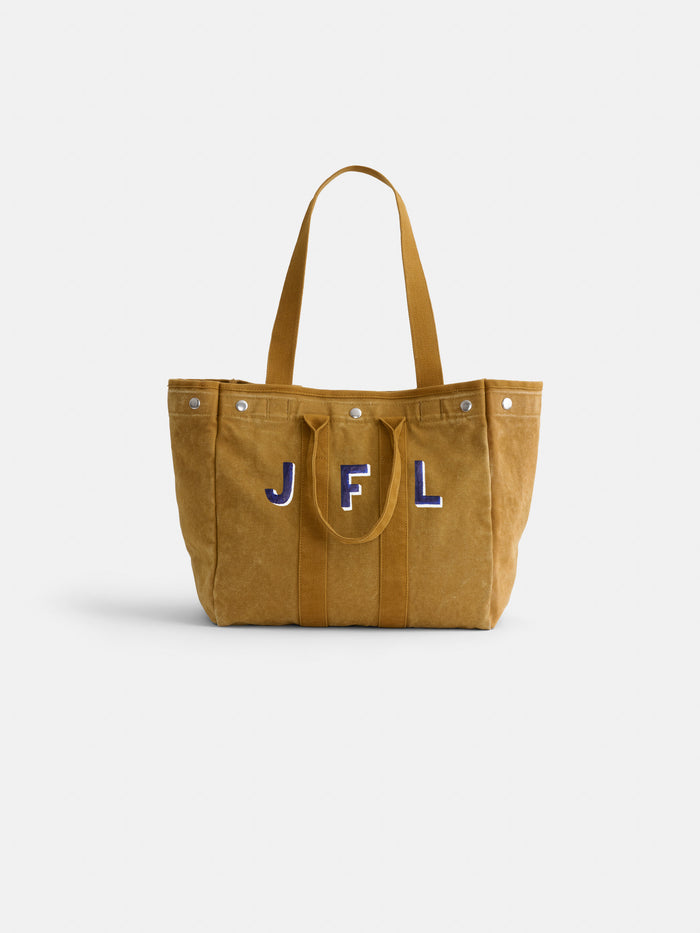 The Perfect Weekday Tote is a tan canvas cotton bag featuring two sturdy handles, button accents along the top edge, and blue and white stitched JFL initials on the front—making it an ideal choice for anyone who appreciates classic, monogrammable totes with a personalized touch.