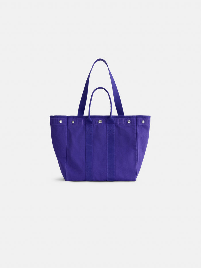 Introducing the Painted Perfect Weekday Tote—a spacious purple canvas bag with both long and short handles, accented by silver rivets and a minimalist design. This personalized tote is ideal for everyday use and is shown against a plain white background.