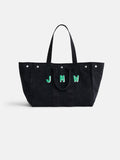 The Perfect Weekend Tote is a large black cotton bag with two handles, silver studs, and a monogram of the letters JMW in green-bordered white font on the front. This personalized tote is displayed against a plain white background.