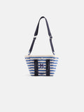 The Striped Mini is a cotton canvas tote with blue and white stripes, navy handles, an adjustable strap, and a bold M logo on the front. This monogrammable bag is shown against a plain white background.