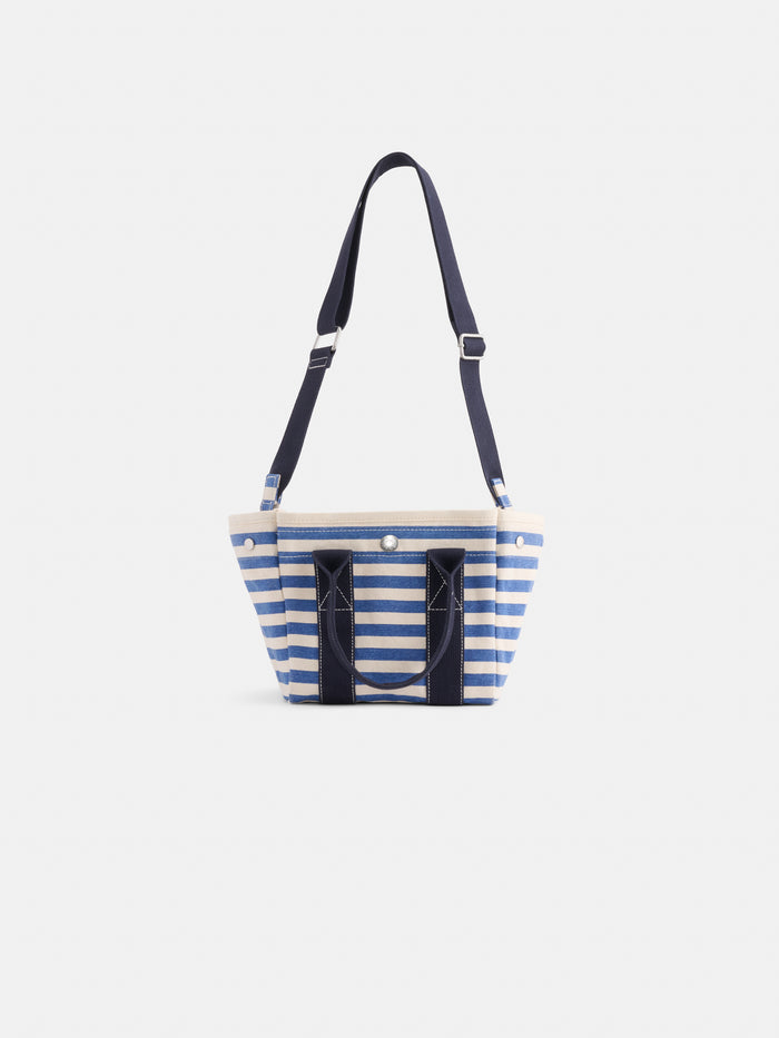 The Striped Mini: a blue and white striped cotton canvas tote with navy handles and an adjustable navy shoulder strap, shown on a plain white background.