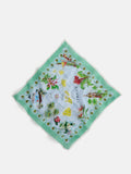 The Travel Scarf in Cotton Voile features a square design with a green border, illustrated map of Hawaii landmarks, tropical flowers, palm trees, and iconic sights set on a light blue background.