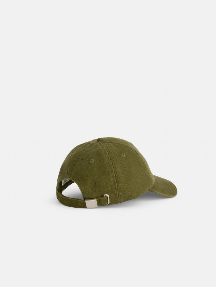 The Washed Canvas Baseball Cap in olive green is displayed from the back, highlighting its adjustable strap with a metal clasp, set against a plain white background.