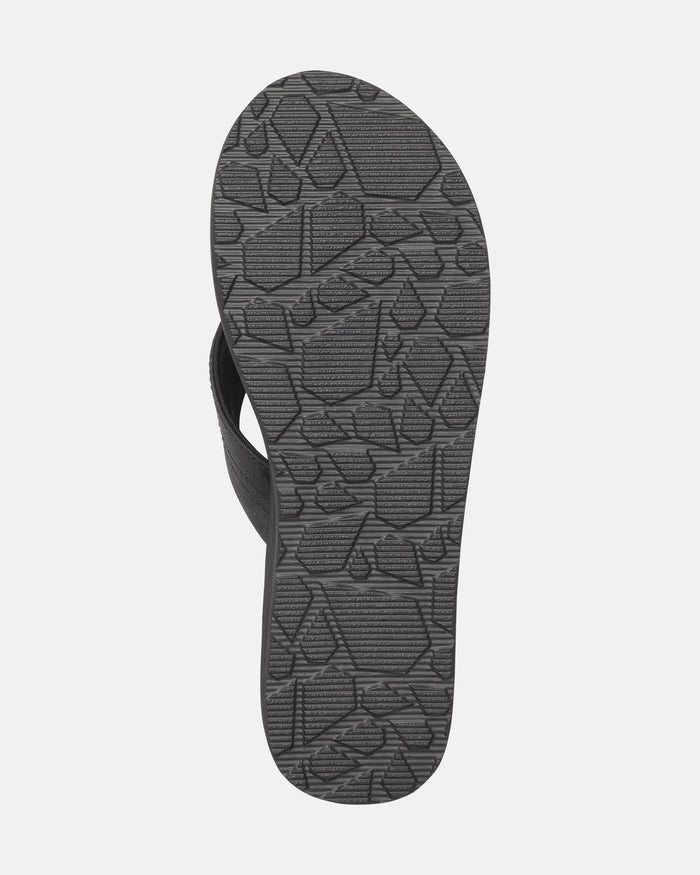 The image shows the bottom view of the Volcom Women's Boyfriends Thong sandal in black, featuring a geometric tread pattern on the sole and built-in arch support for comfort.