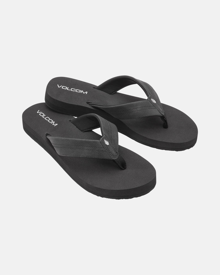 A pair of Volcom Women's Boyfriends Thong sandals in black, featuring fabric straps, a minimalist design, and a comfort foam footbed, displayed on a white background.