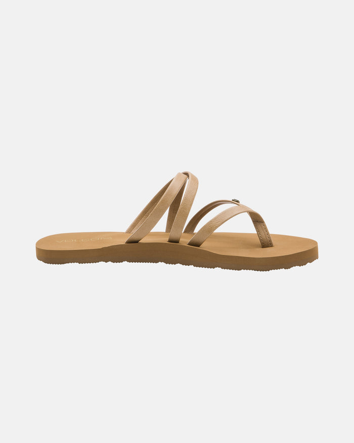 The Volcom Women's Easy Breezy II sandal features a tan strappy design with three thin, crisscrossing straps, a brown sole, and built-in arch support, shown on a plain white background.