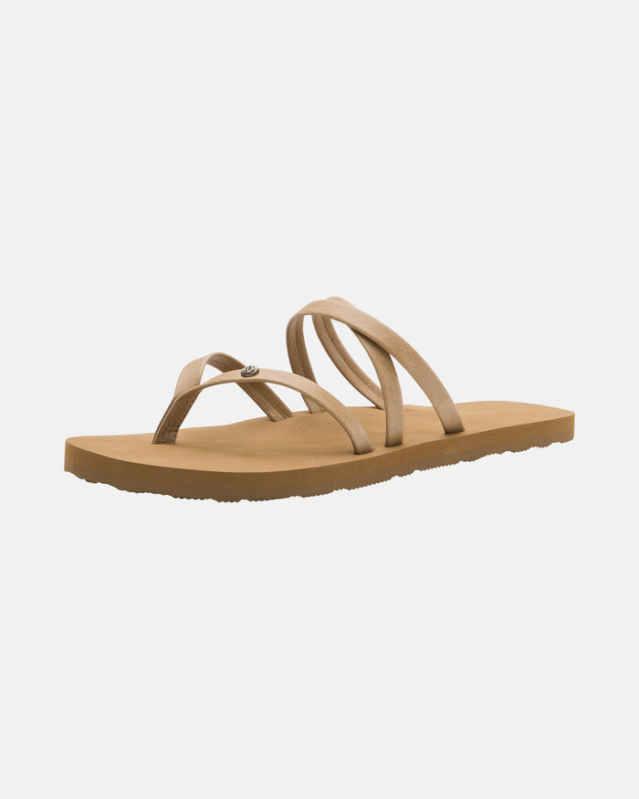 The Women's Easy Breezy II by Volcom is a tan strappy sandal with a flat sole and three thin crisscrossing straps, designed for casual wear. It features an EVA footbed for comfort and is shown on a plain white background.