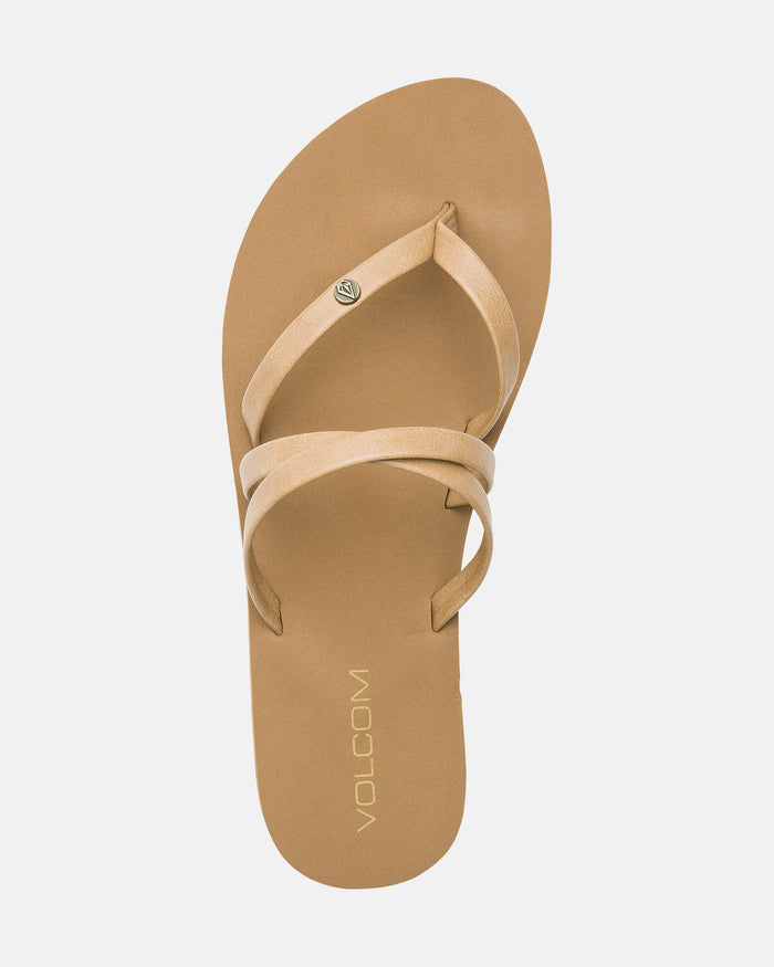 Tan Volcom Women's Easy Breezy II sandals with two crisscross straps and a small metal logo, shown from above on a white background. Features an EVA footbed for comfort and subtle arch support.