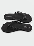 A pair of Volcom Women's Forever And Ever II black flip-flops, featuring thin synthetic leather straps and "VOLCOM" printed in white on the footbeds, with molded arch support for added comfort, displayed on a white background.