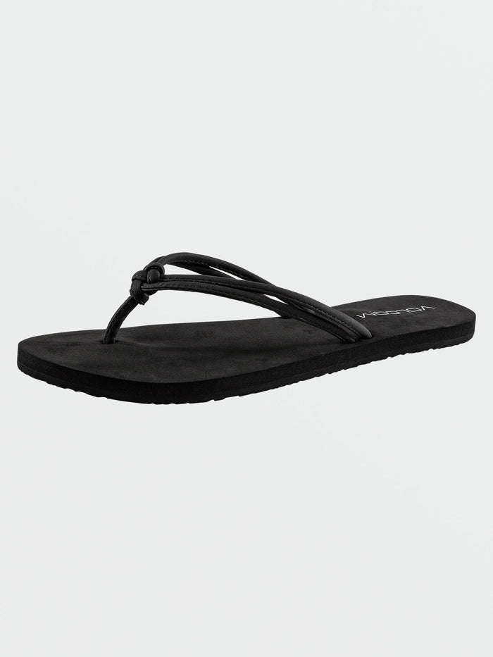 The Volcom Women's Forever And Ever II is a black flip-flop sandal featuring a thin, double strap design and a flat sole crafted from Recliner Comfort Foam, displayed on a plain white background.