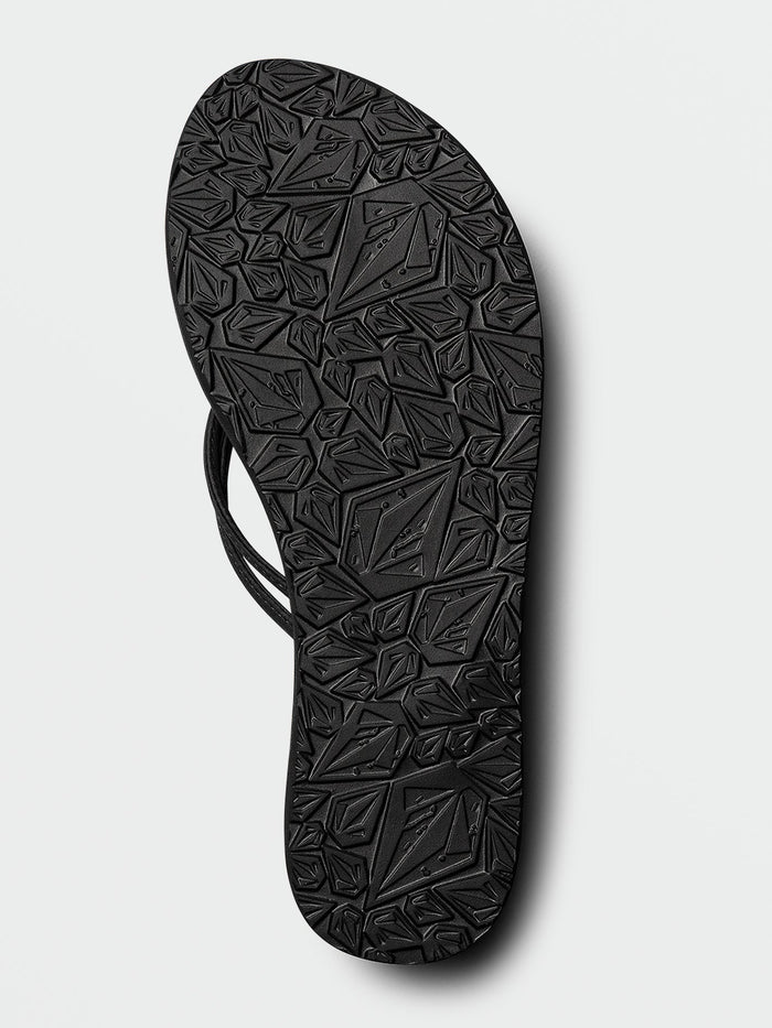 Here is your rewritten sentence using the provided product data: The Volcom Women's Forever And Ever II sandal, shown from the bottom against a plain white background, highlights its textured geometric tread sole, Synthetic Leather Straps at the sides, and Molded Arch Support for enhanced comfort.