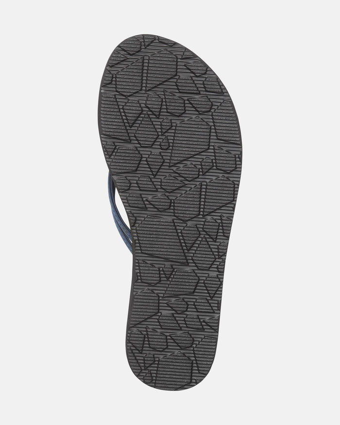 The underside of the Volcom Women's Forever And Ever II flip-flop sandal shows a textured dark gray sole with a geometric pattern and black horizontal lines. Part of the sandal straps appears on the left side.