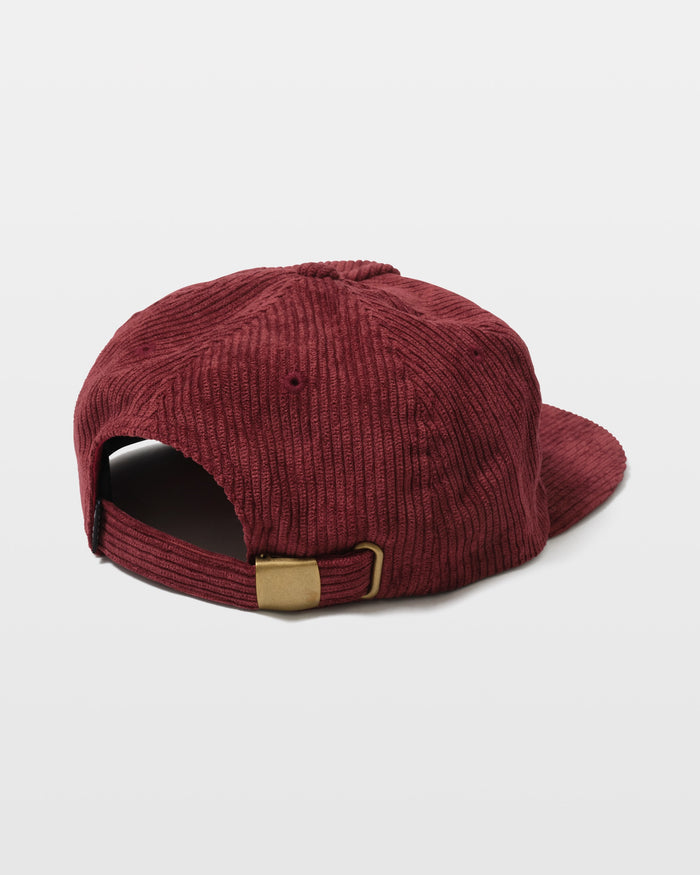 The Volcom Women's Full Stone Dad Hat is shown from the back, displaying its red corduroy material, adjustable strap with brass buckle, and opening above the strap, set against a plain white background.