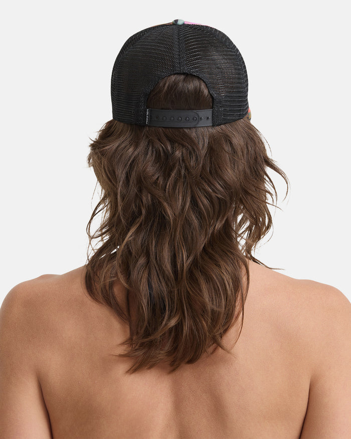 A woman with long, wavy brown hair is shown from the back, wearing the Volcom Women's Into Paradise Hat against a white background.