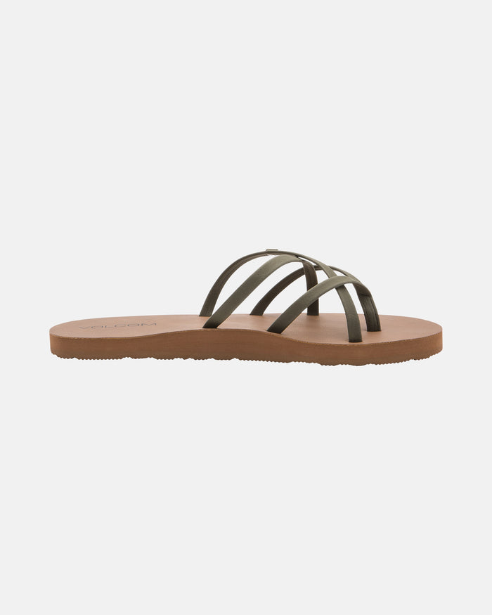 The Volcom Women's New School II sandal features thin black synthetic leather straps in a crisscross design over a brown sole. Shown in side profile on a white background, it offers Recliner Comfort Foam for cushioning and arch support.