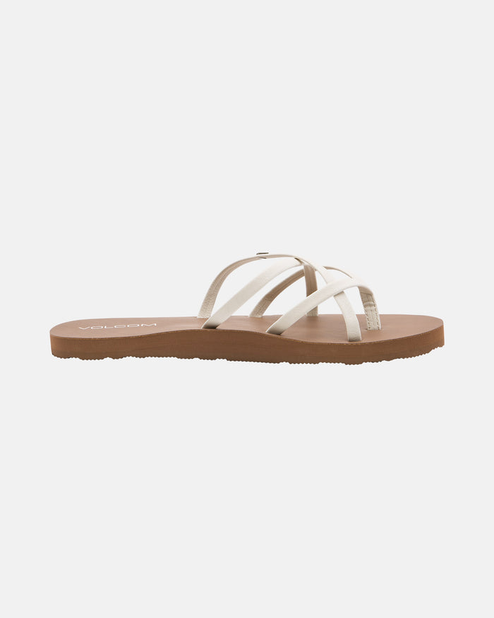 The Volcom Women's New School II sandal features thin, crisscrossed synthetic leather straps and a flat brown sole with Recliner Comfort Foam, displayed on a plain white background.