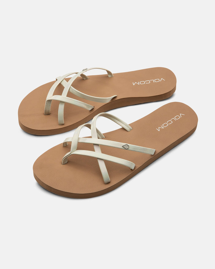 The Volcom Women's New School II sandals feature tan synthetic leather crisscross straps, molded arch support, recliner comfort foam, and a VOLCOM logo on the insole.