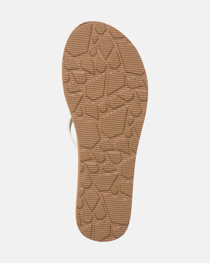 The image displays the sole of Volcom Women's New School II sandal in tan, featuring a textured geometric pattern for grip and molded arch support. Synthetic leather straps are partially visible at the top against a white background.
