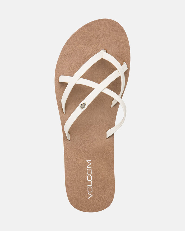 A top view of the Volcom Women's New School II sandal shows brown soles with white synthetic leather crisscross straps, molded arch support, Recliner Comfort Foam, and a Volcom logo near the heel on a plain white background.