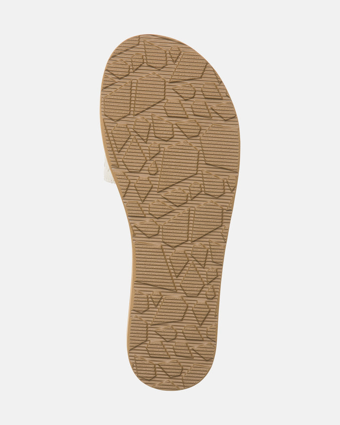 The image shows the bottom view of the Volcom Women's Simple Slides Braid Sandals. The tan sole features a textured, geometric pattern for grip, set against a plain white background.