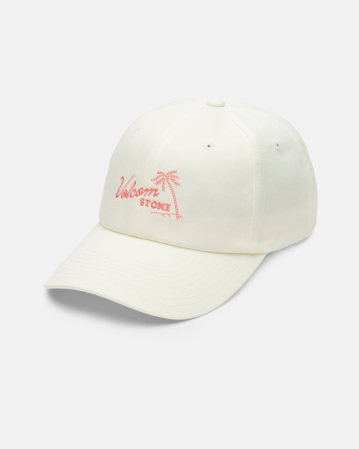 The Volcom Women's Stone Rising Hat is an ivory cotton, unstructured 6-panel hat with a pink palm tree and Welsom Stone embroidered on the front, an adjustable back strap, shown against a white background.
