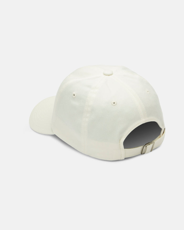 The Women's Stone Rising Hat by Volcom is displayed from the back, highlighting its adjustable metal-buckle strap. This unstructured 6-panel ivory cotton cap appears against a plain white background.