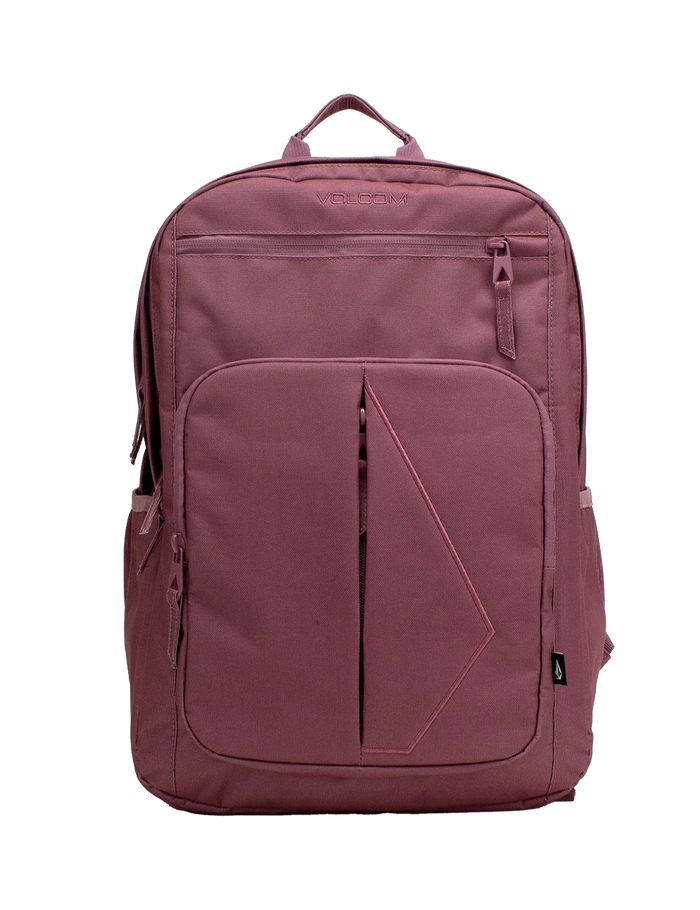 A Volcom Women’s Study Buddy Backpackq in mauve, featuring a geometric front pattern, front zipper pocket, side pockets, top handle, and a padded laptop sleeve for convenience. Shown on a plain white background.