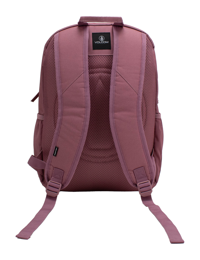 The Volcom Women's Study Buddy Backpackq in mauve is displayed from the back against a white background, highlighting its padded shoulder straps, mesh back panel, interior padded laptop sleeve, and adjustable bottom straps.