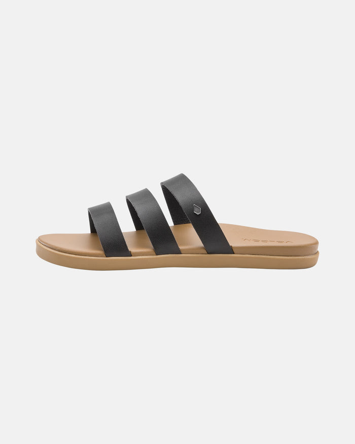 The Volcom Women's Sunseeker Sandals feature a tan sole and three black leather straps across the top, shown on a white background.