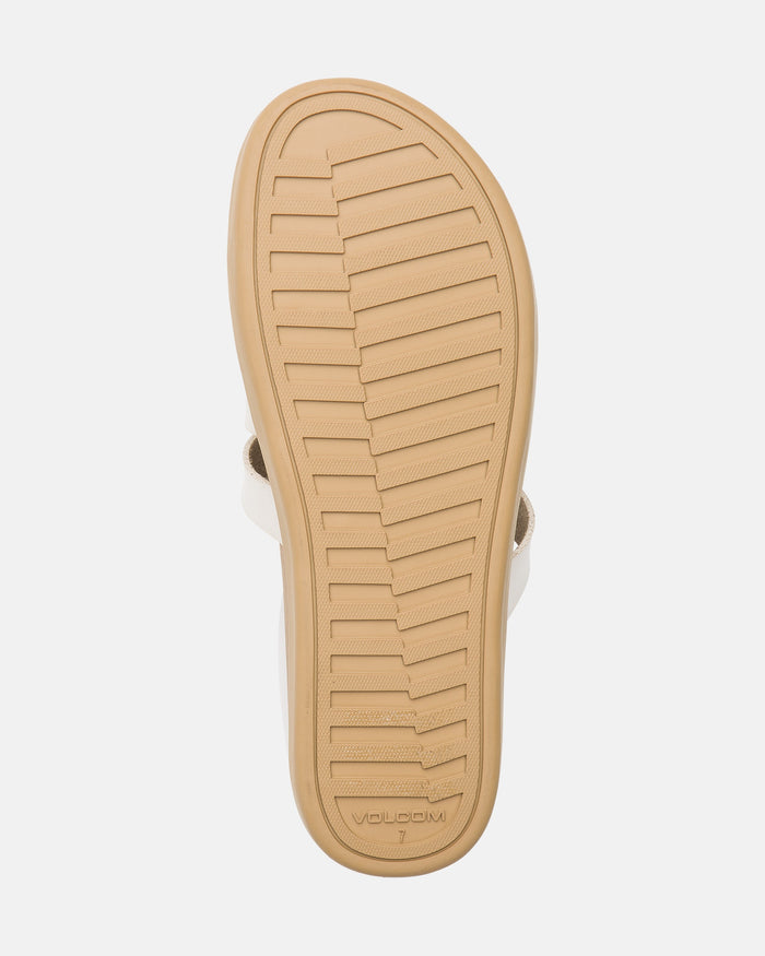 The image shows the bottom sole of a beige Women's Sunseeker Sandal by Volcom, featuring a textured, ribbed tread pattern with "MODENA" and the number 7 imprinted near the heel.