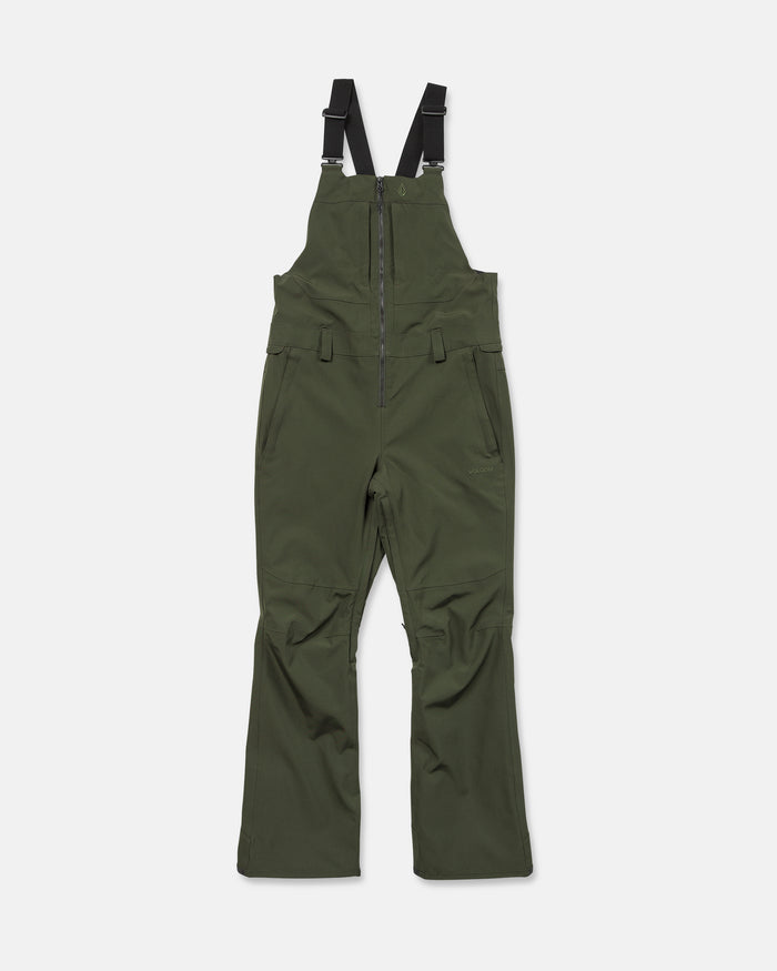 The Volcom Women’s Swift Bib in olive green is crafted from recycled fabric and features black adjustable shoulder straps, a front zipper, and side pockets. It is displayed on a plain white background.