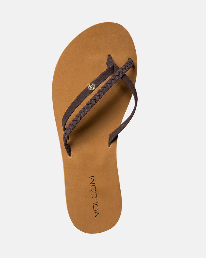 The Volcom Women's Thrills II sandal features synthetic leather braided dark brown straps, molded arch support, and the Volcom logo printed on its tan footbed.