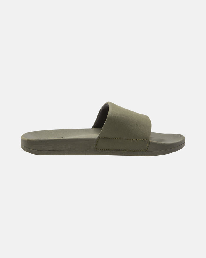 A single Women's Volcation Slide by Volcom in olive green, shown from the side with a wide top strap and flat sole, showcases signature style and everyday comfort on a plain white background.