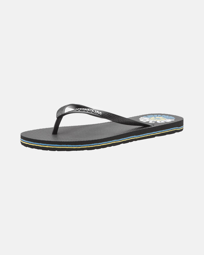 The Women's Volcomotion Wos Hawaii by Volcom is a black flip-flop sandal with thin black straps, a small Volcom logo, a textured sole, a colorful graphic on the footbed near the heel, and a thin striped edge on the sole.