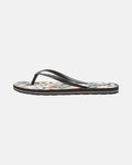 The Women's Volcomotion Womens by Volcom is a single flip-flop sandal with black straps and a vibrant floral-patterned footbed, shown in side profile on white, delivering everyday comfort and signature Volcom style.