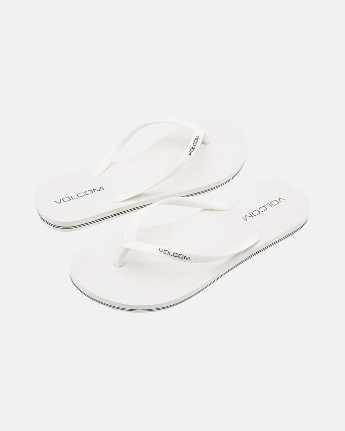 A pair of Volcom Volcomotion Womens white flip-flops with thin straps, featuring the black Volcom logo on the footbeds and straps, shown against a plain white background.