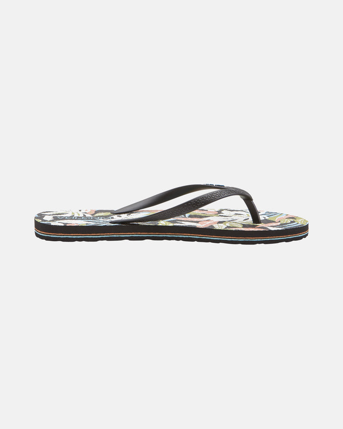 The Volcom Women's Volcomotion flip-flop sandal features thin straps and a floral-patterned sole in black, delivering everyday comfort and iconic style. Shown in side profile on a white background.