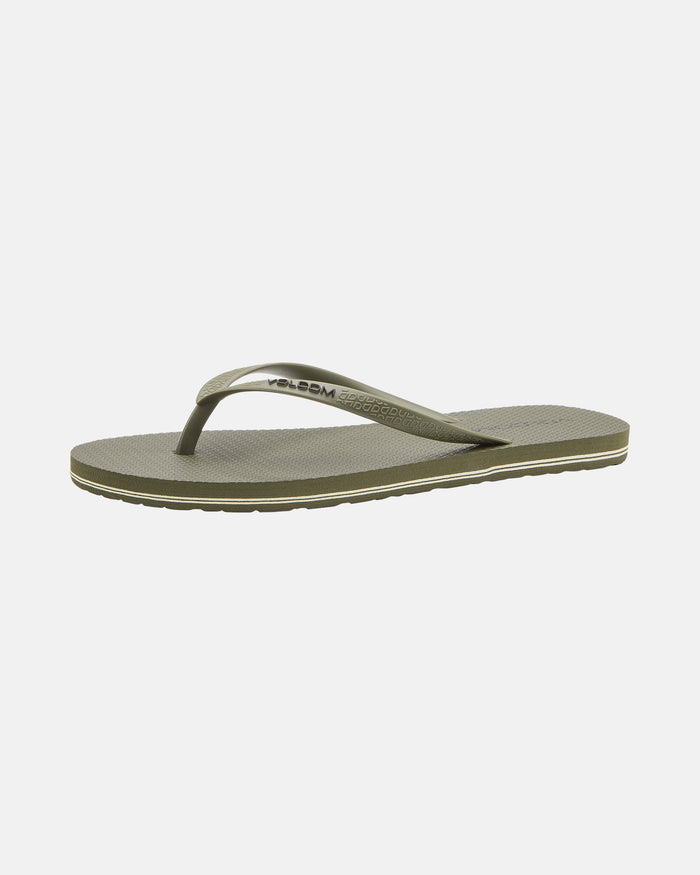 The Volcomotion Womens sandal by Volcom features an olive green color, textured sole, and thin matching strap with the Volcom logo on the side. Displayed against a white background.