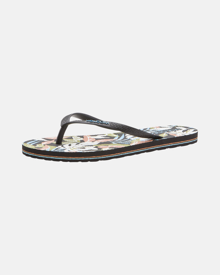 The Volcom Women's Volcomotion Womens sandal features black straps and a vibrant tropical floral sole, offering everyday comfort and signature Volcom style, shown against a plain white background.