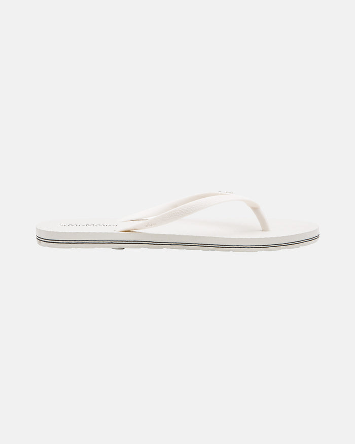 The Volcom Volcomotion Womens sandal features a flat sole and thin straps in white, shown on a plain white background.