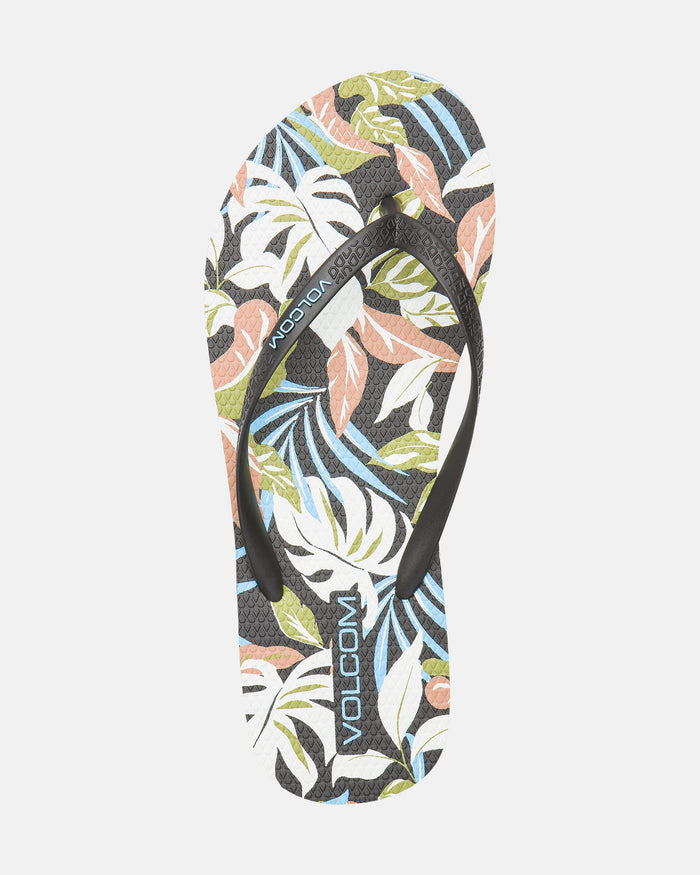 The Women's Volcomotion Womens sandal by Volcom features a black strap and a vibrant tropical leaf print in green, blue, peach, and white, with the VOLCOM logo on the strap and footbed for signature style.